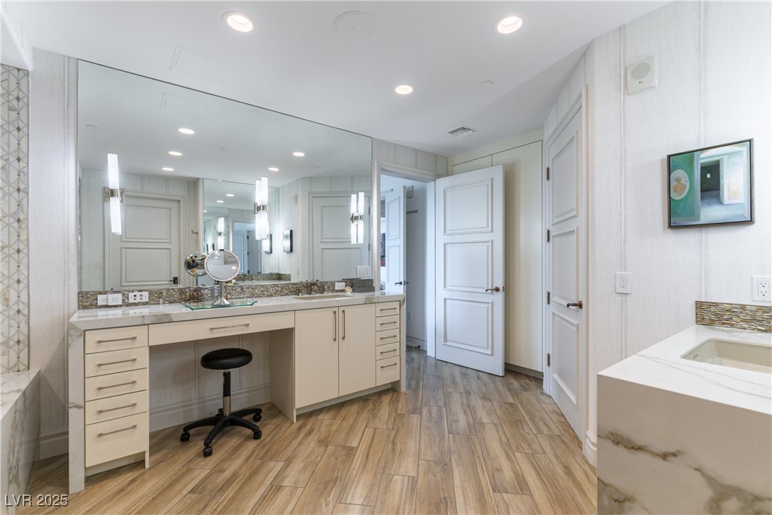 9101 Alta Drive, Unit 505 Las Vegas, NV 89145 - Photo 26 of 64 Bathroom featuring wood finished floors, vanity, recessed lighting, and a tub