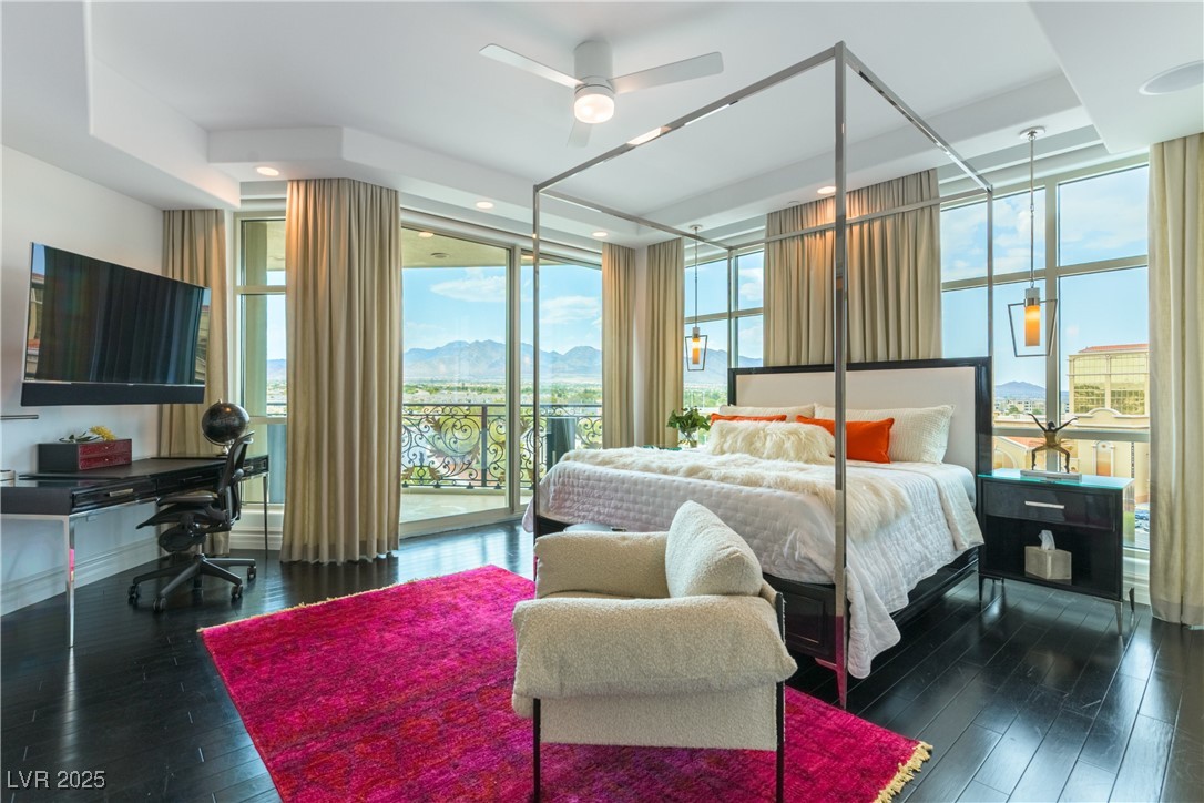 9101 Alta Drive, Unit 505 Las Vegas, NV 89145 - Photo 39 of 64 Bedroom with floor to ceiling windows, multiple windows, access to outside, a mountain view, and an office area