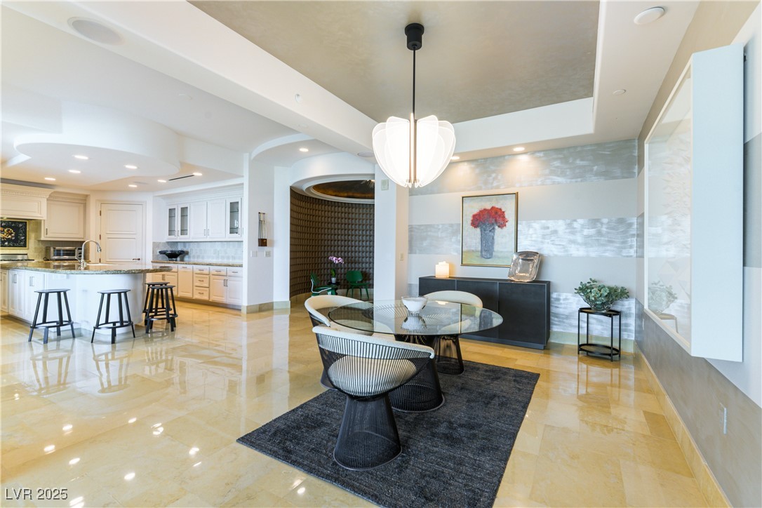 9101 Alta Drive, Unit 505 Las Vegas, NV 89145 - Photo 4 of 64 Dining space with recessed lighting, a tray ceiling, and light marble finish flooring