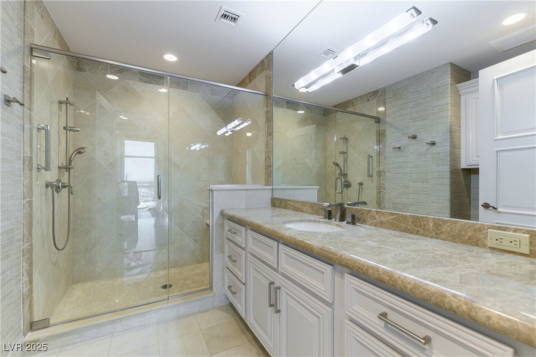 9101 Alta Drive, Unit 505 Las Vegas, NV 89145 - Photo 45 of 64 Full bath featuring vanity, a shower stall, tile patterned floors, and recessed lighting