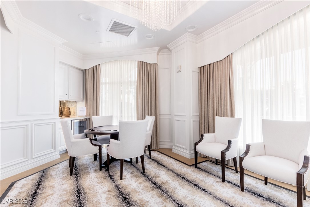 9101 Alta Drive, Unit 505 Las Vegas, NV 89145 - Photo 51 of 64 Office area with ornamental molding, a decorative wall, plenty of natural light, and a chandelier