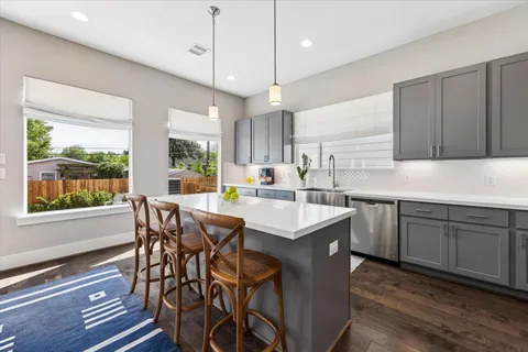 a kitchen with a table chairs stove and cabinets