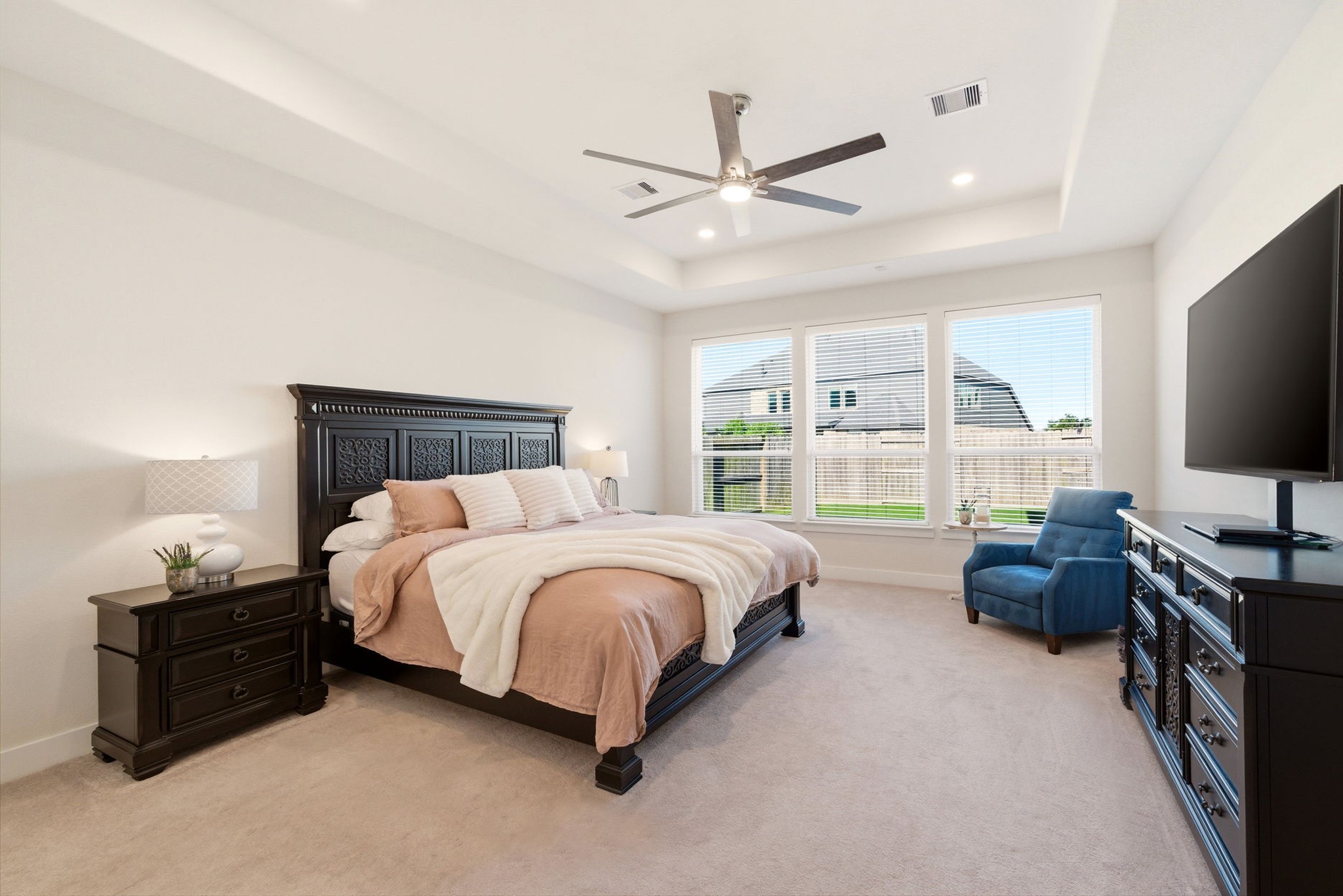 28811 Ember Crest Lane Fulshear, TX 77441 - Photo 4 of 47 a spacious bedroom with a bed and a flat screen tv