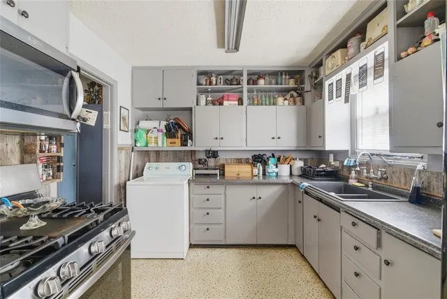 a kitchen with cabinets and appliances