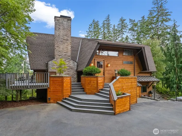 a view of a chair and table in the back yard of the house