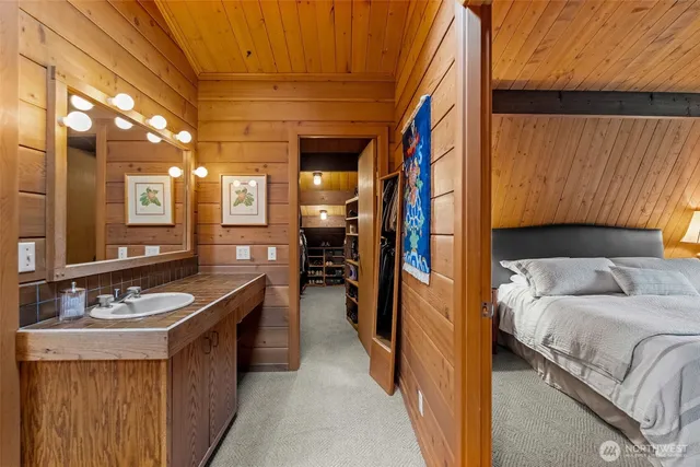 a bathroom with a sink a toilet a mirror and shower