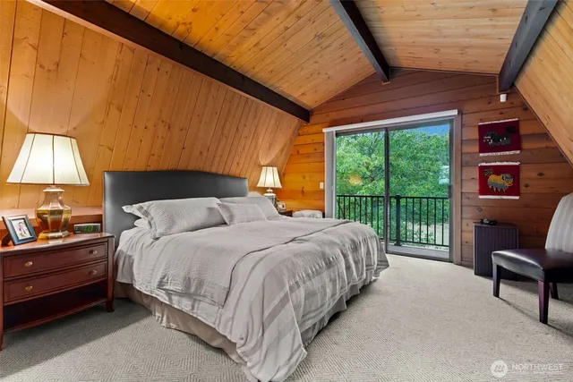 a spacious bedroom with a bed and wooden floor