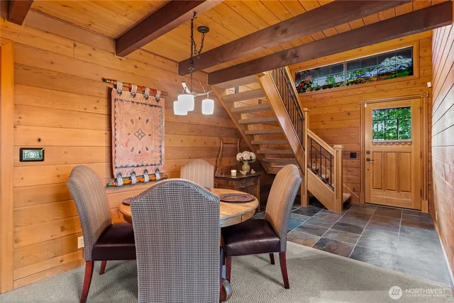 a view of a patio with table and chairs with wooden floor and fence