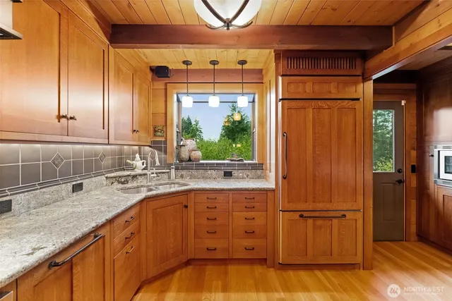 a kitchen with wooden cabinets and sink