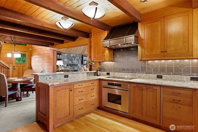 a kitchen with a stove top oven cabinets and a window