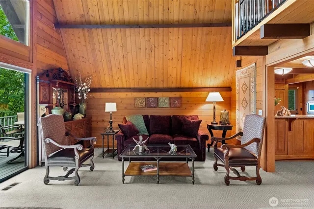 a living room with furniture a fireplace and a bookshelf