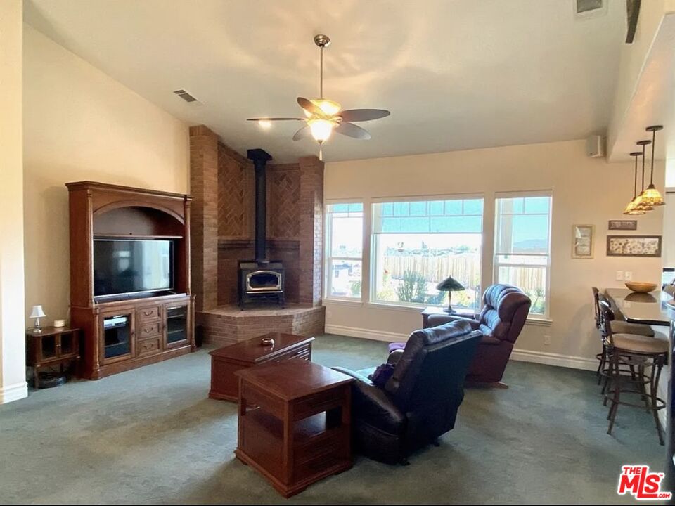 7173 Barker Road Oak Hills, CA 92344 - Photo 14 of 26 a living room with furniture and a flat screen tv