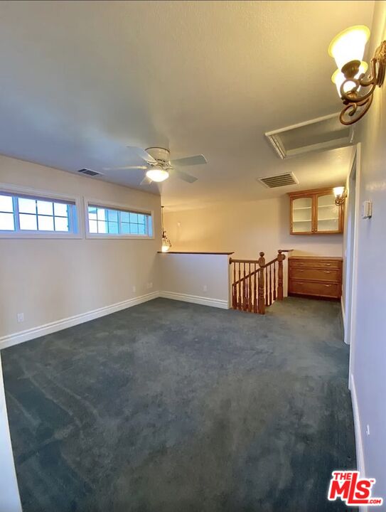 7173 Barker Road Oak Hills, CA 92344 - Photo 18 of 26 a view of a room with a staircase
