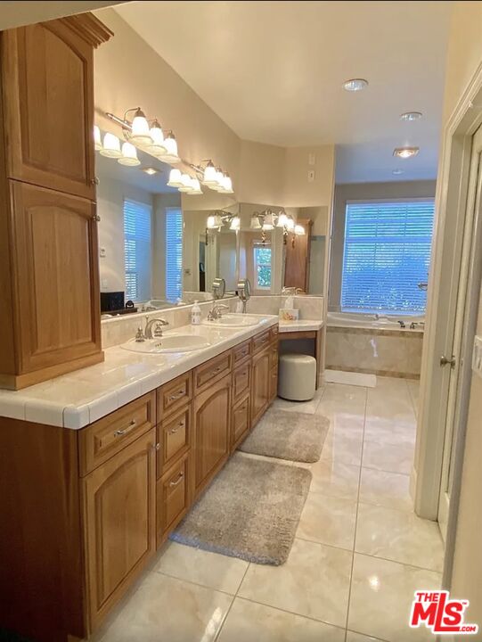 7173 Barker Road Oak Hills, CA 92344 - Photo 19 of 26 a bathroom with a sink a toilet and mirror