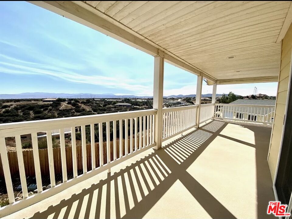 7173 Barker Road Oak Hills, CA 92344 - Photo 21 of 26 a view of balcony with couch and wooden floor
