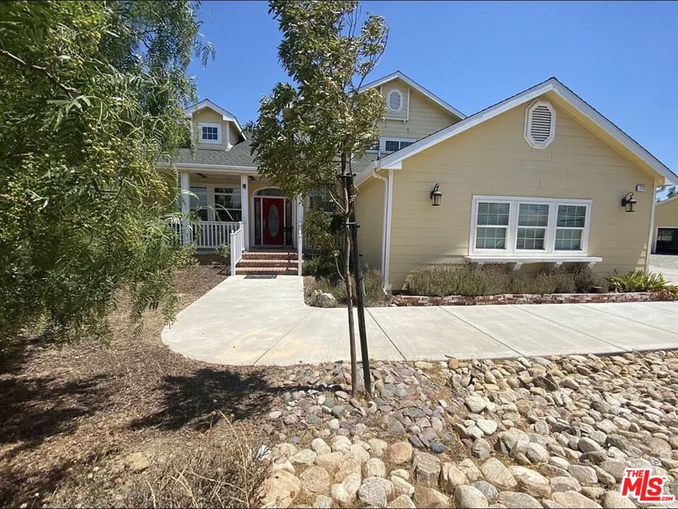 7173 Barker Road Oak Hills, CA 92344 - Photo 3 of 26 a front view of a house with a yard and garage