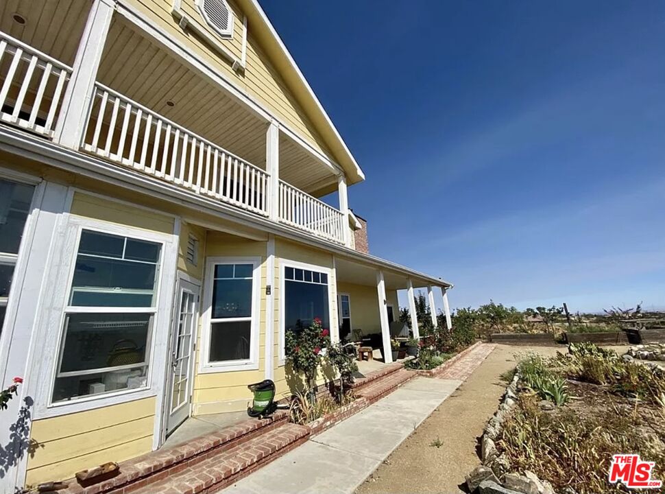 7173 Barker Road Oak Hills, CA 92344 - Photo 4 of 26 a front view of a house with a yard
