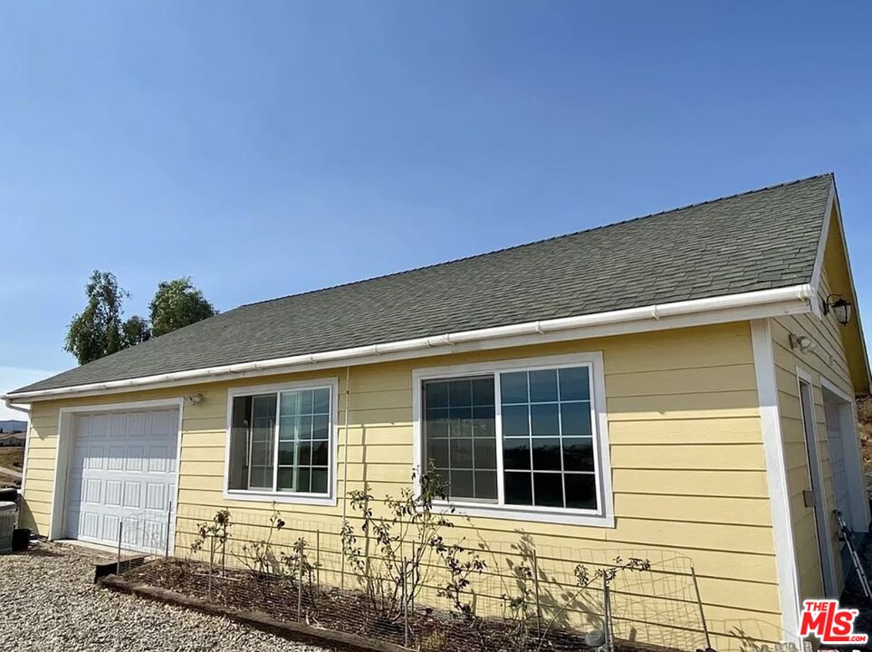 7173 Barker Road Oak Hills, CA 92344 - Photo 5 of 26 a front view of a house with glass windows