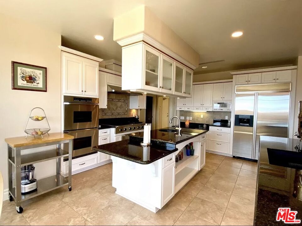 7173 Barker Road Oak Hills, CA 92344 - Photo 7 of 26 a large kitchen with stainless steel appliances granite countertop a lot of counter top space