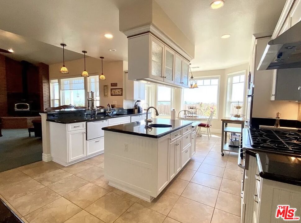 7173 Barker Road Oak Hills, CA 92344 - Photo 8 of 26 a kitchen with stainless steel appliances granite countertop a sink and a stove