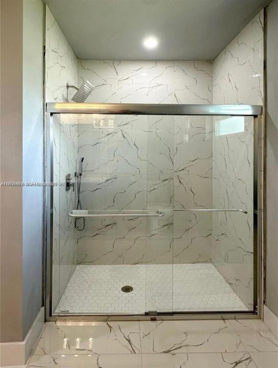 868 Cervantes Street East Lehigh Acres, FL 33974 - Photo 11 of 18 a bathroom with a shower