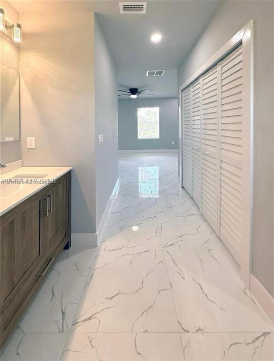868 Cervantes Street East Lehigh Acres, FL 33974 - Photo 12 of 18 a view of a bathroom with sink and mirror