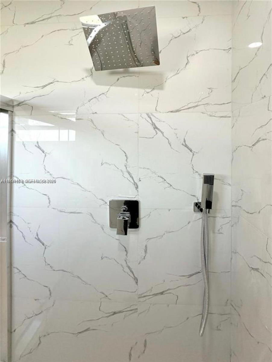 868 Cervantes Street East Lehigh Acres, FL 33974 - Photo 13 of 18 a bathroom with a shower