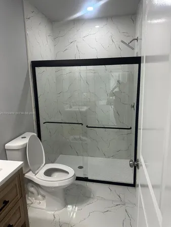 a bathroom with a sink vanity and toilet