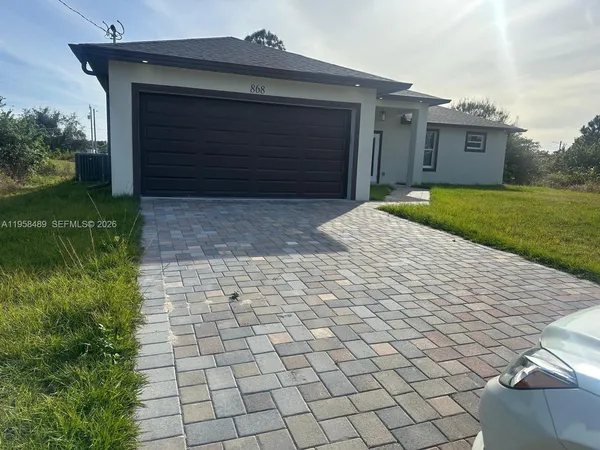 a kitchen with stainless steel appliances white cabinets and black appliances
