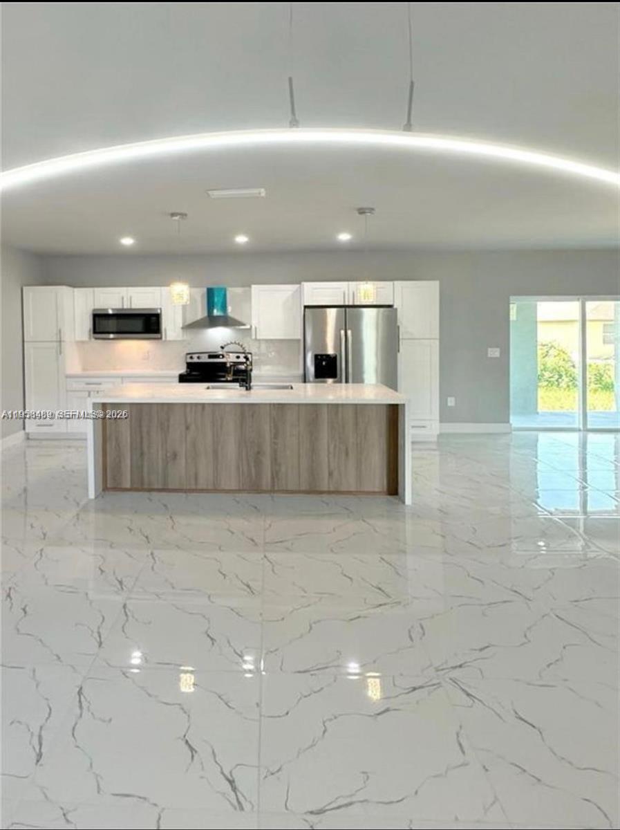 868 Cervantes Street East Lehigh Acres, FL 33974 - Photo 4 of 18 a view of kitchen with stainless steel appliances a sink and a counter top space
