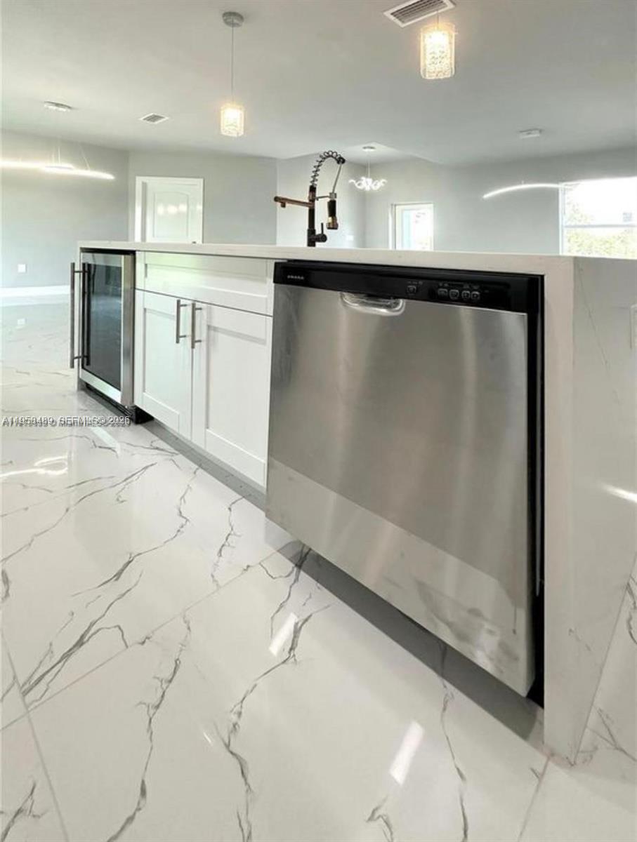 868 Cervantes Street East Lehigh Acres, FL 33974 - Photo 6 of 18 a view of a refrigerator in kitchen and a window