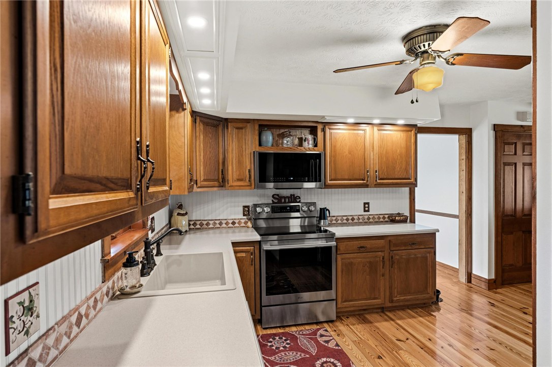 4971 Lackey Road Cedarville, OH 45314 - Photo 26 of 79 This warm kitchen features wooden cabinetry and light countertops, perfect for everyday living.
