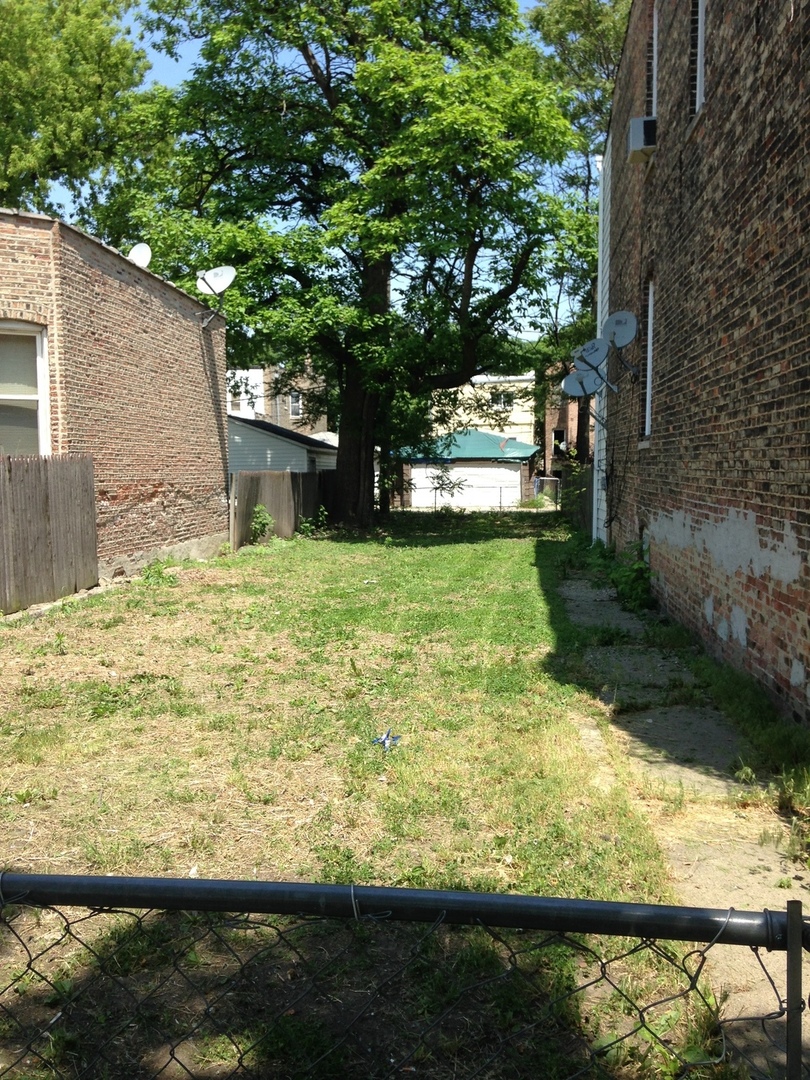 a view of a yard with an outdoor seating