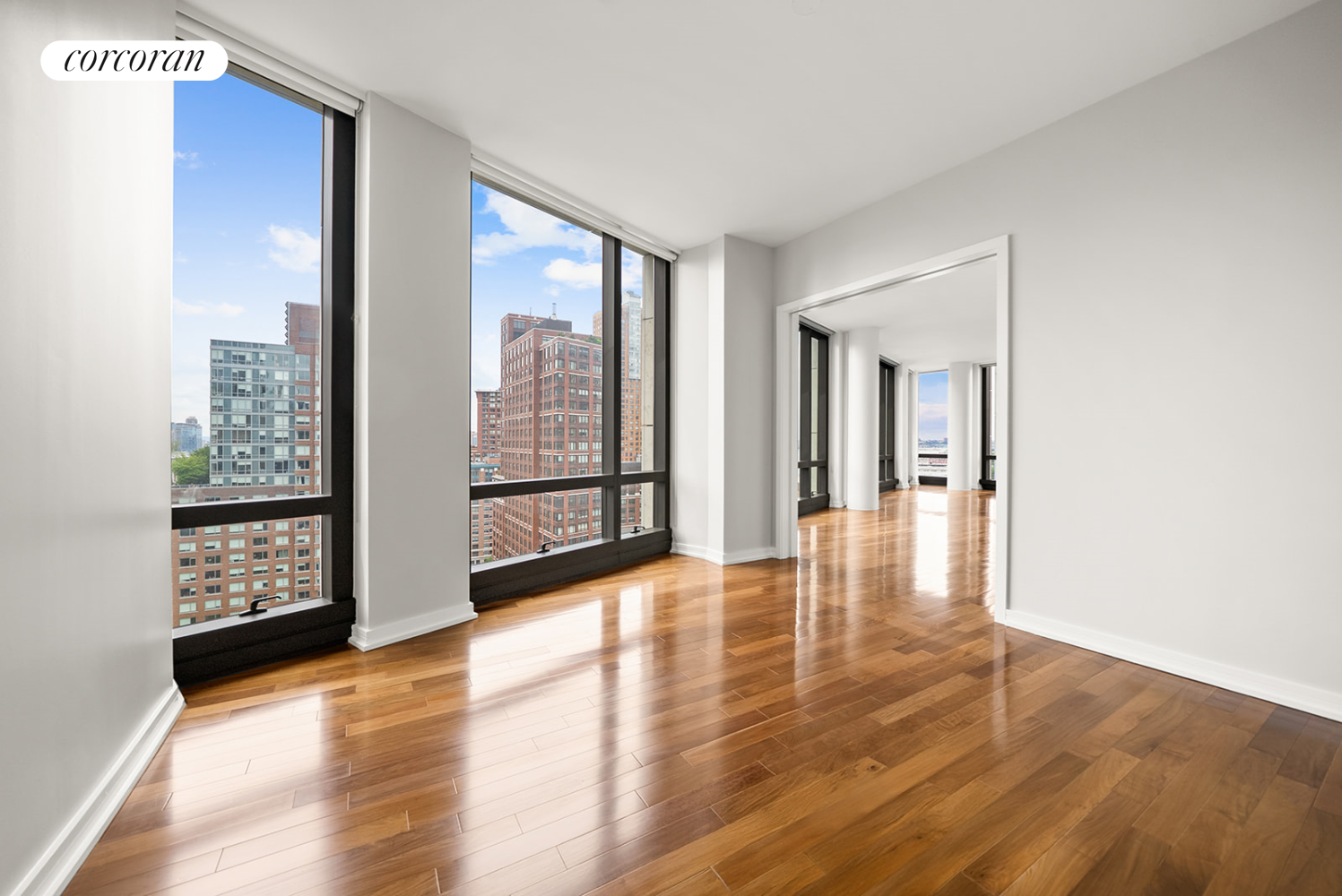 101 Warren Street, Unit 1720 Manhattan, NY 10007 - Photo 11 of 21 a view of an empty room with wooden floor and a window