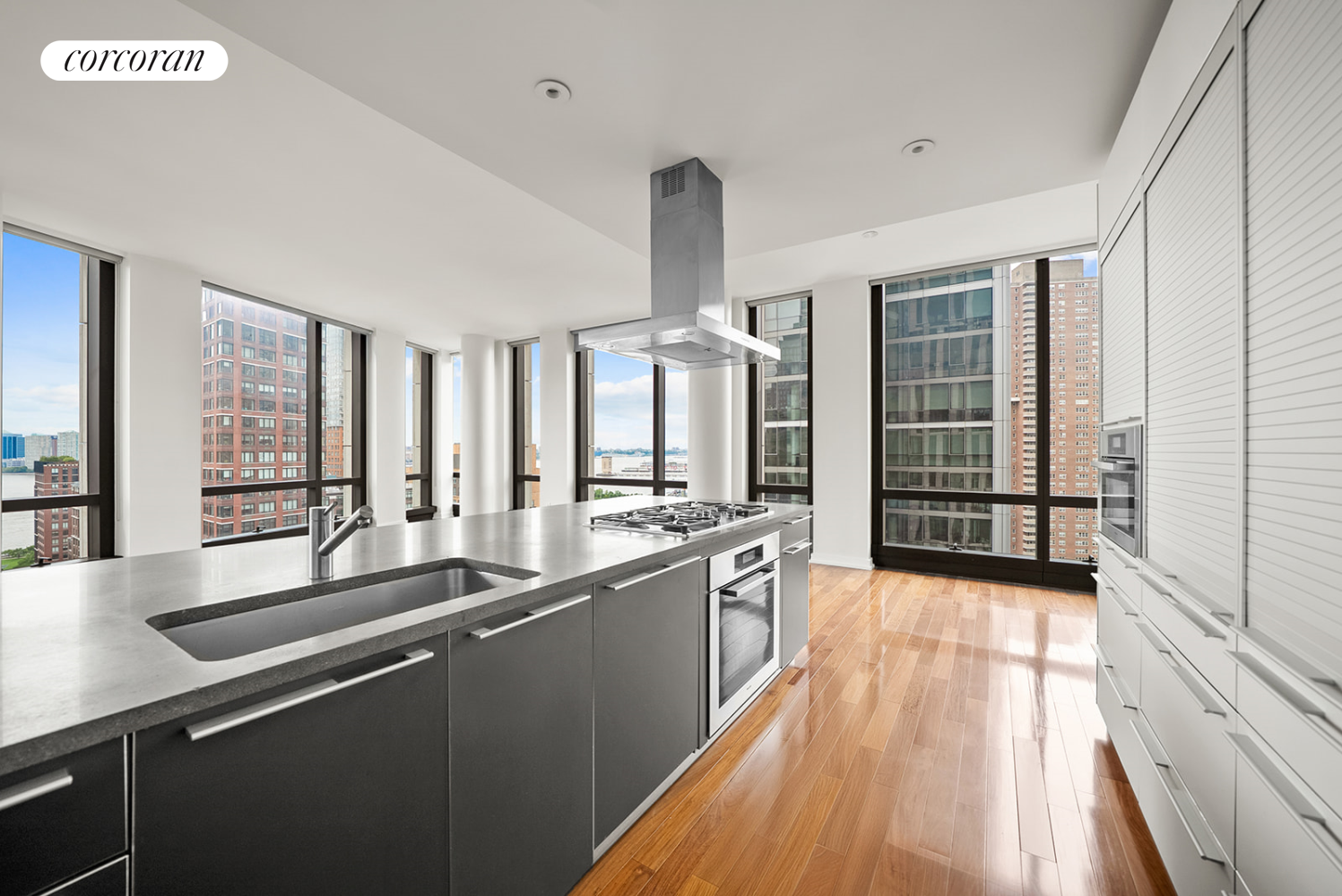 101 Warren Street, Unit 1720 Manhattan, NY 10007 - Photo 5 of 21 a large kitchen with granite countertop a sink and dishwasher with a large window