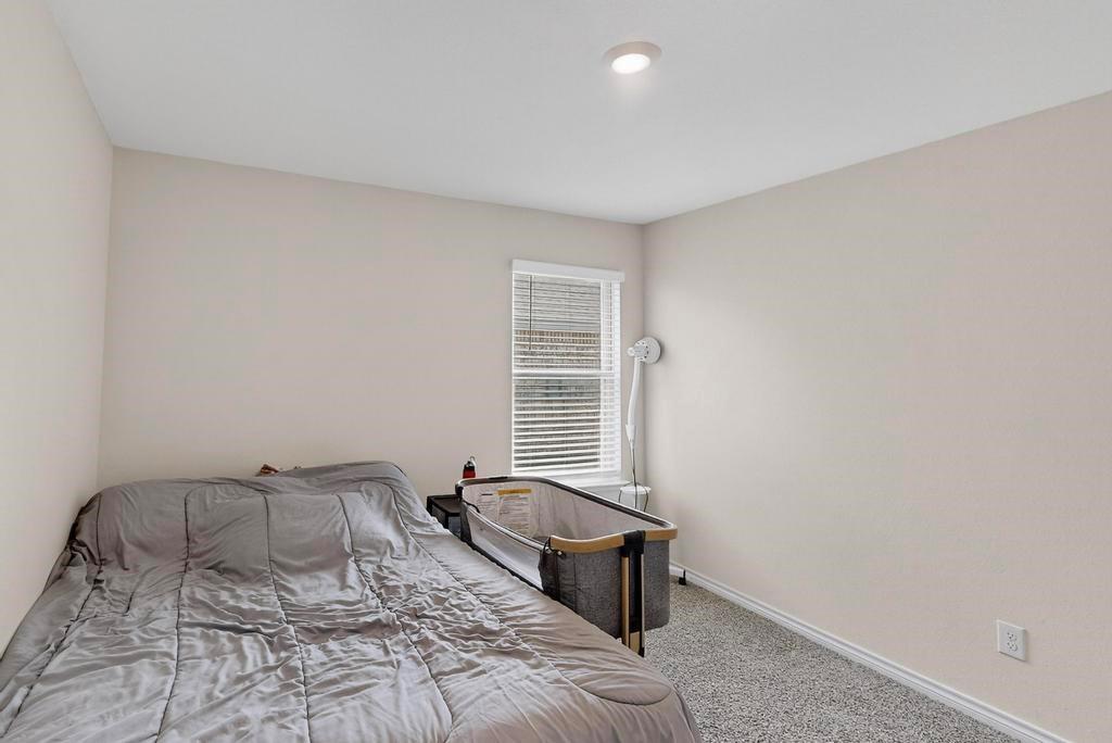 504 Willow View Way Princeton, TX 75407 - Photo 11 of 21 a bedroom with a bed and a chair