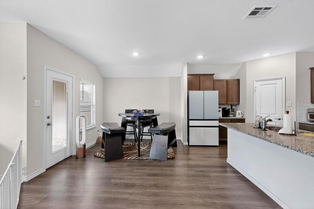 504 Willow View Way Princeton, TX 75407 - Photo 7 of 21 a large white kitchen with a refrigerator a sink dishwasher a stove and a refrigerator with wooden floor