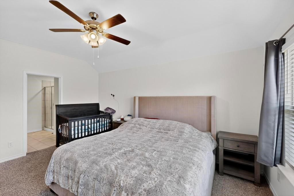 504 Willow View Way Princeton, TX 75407 - Photo 9 of 21 a bedroom with a bed and a chandelier