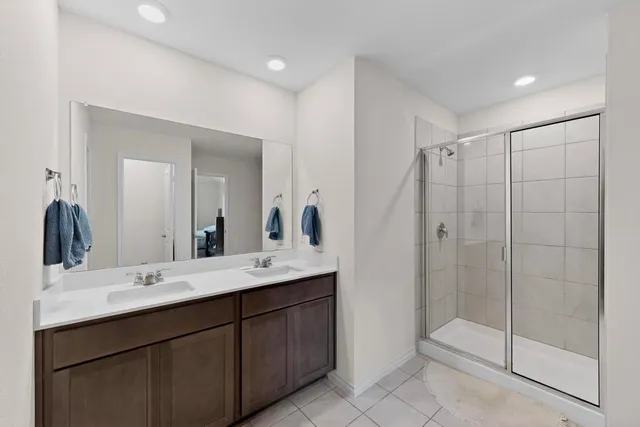 a bathroom with a shower sink and mirror