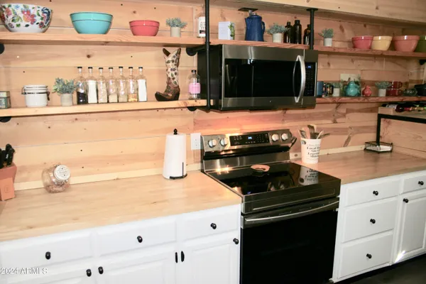 a kitchen with granite countertop a sink and a stove