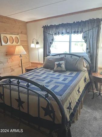 a bed sitting in a bedroom next to a window