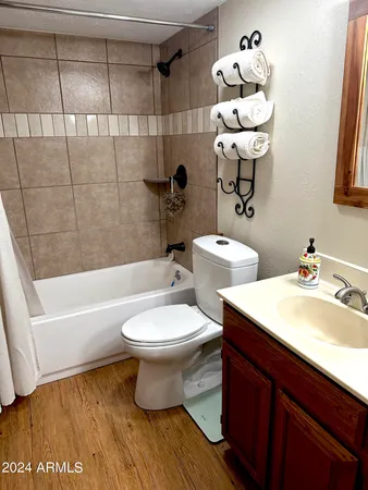 a bathroom with a sink a toilet and bathtub