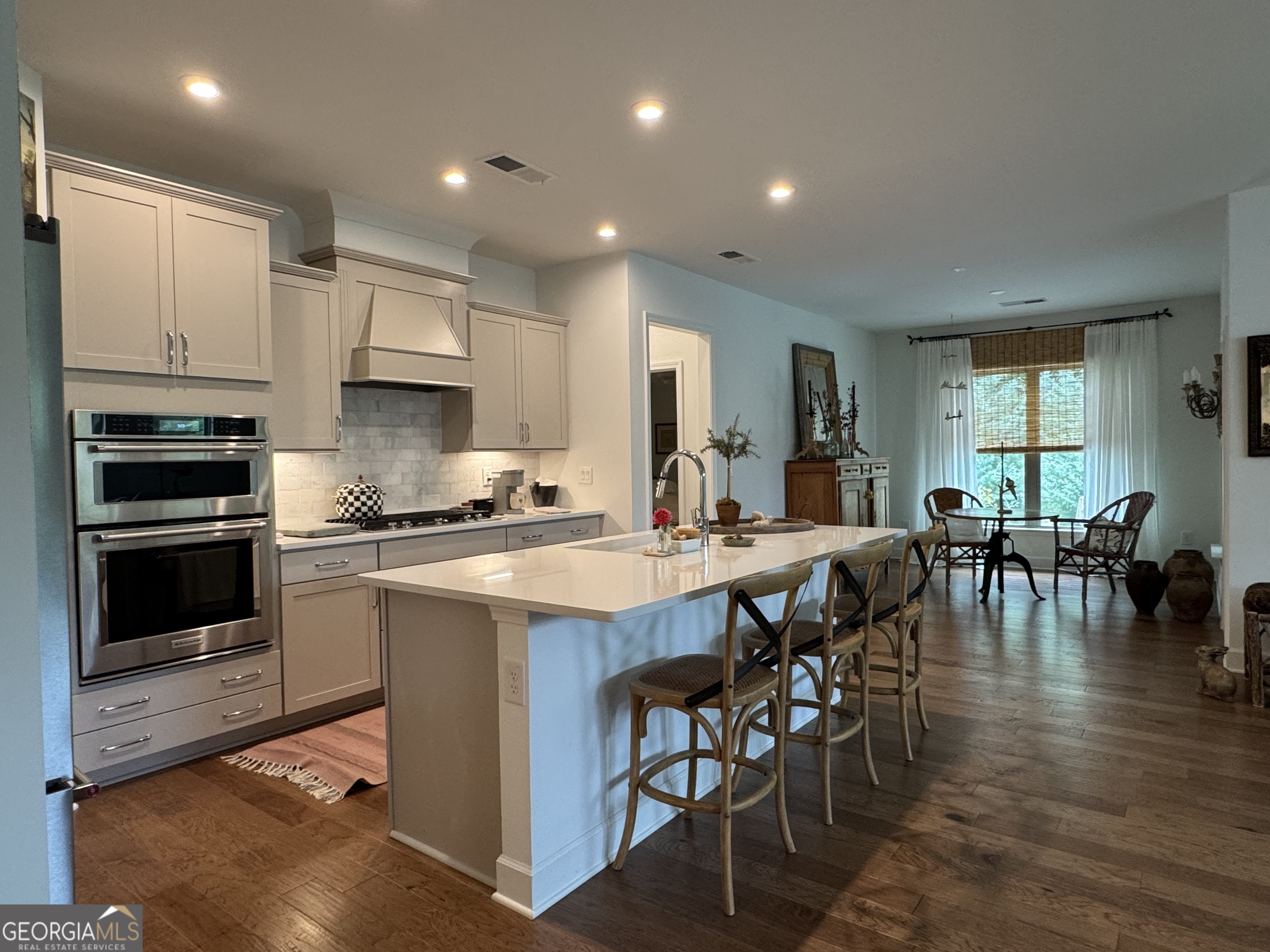 5947 Maple Bluff Way Hoschton, GA 30548 - Photo 11 of 32 a large kitchen with lots of counter space a sink and appliances