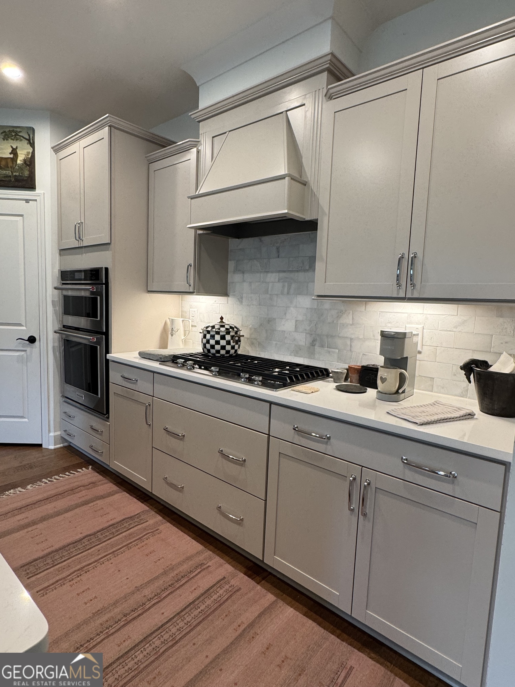 5947 Maple Bluff Way Hoschton, GA 30548 - Photo 14 of 32 a kitchen with cabinets appliances and a counter space