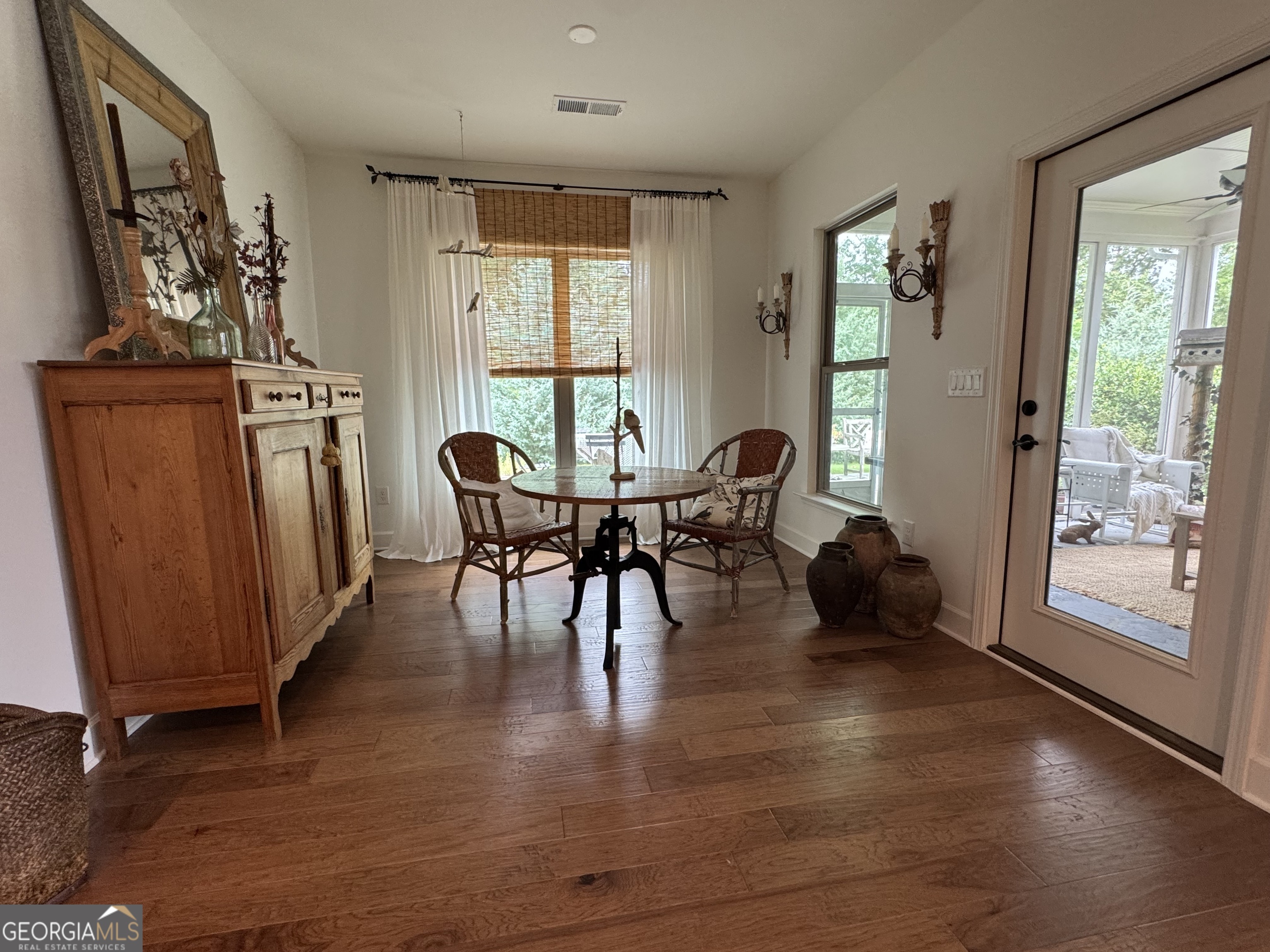 5947 Maple Bluff Way Hoschton, GA 30548 - Photo 16 of 32 a view of a dining room with furniture and chandelier