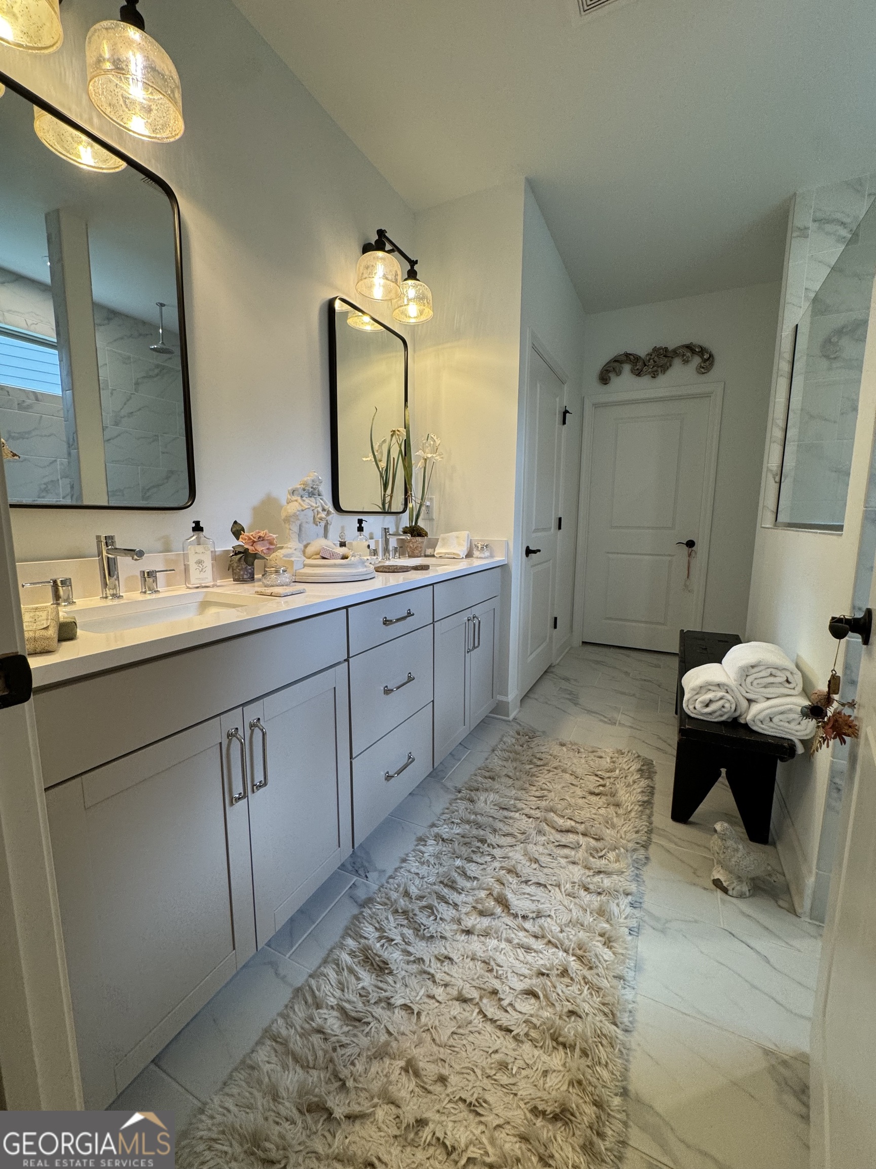5947 Maple Bluff Way Hoschton, GA 30548 - Photo 18 of 32 a spacious bathroom with a tub sink and mirror