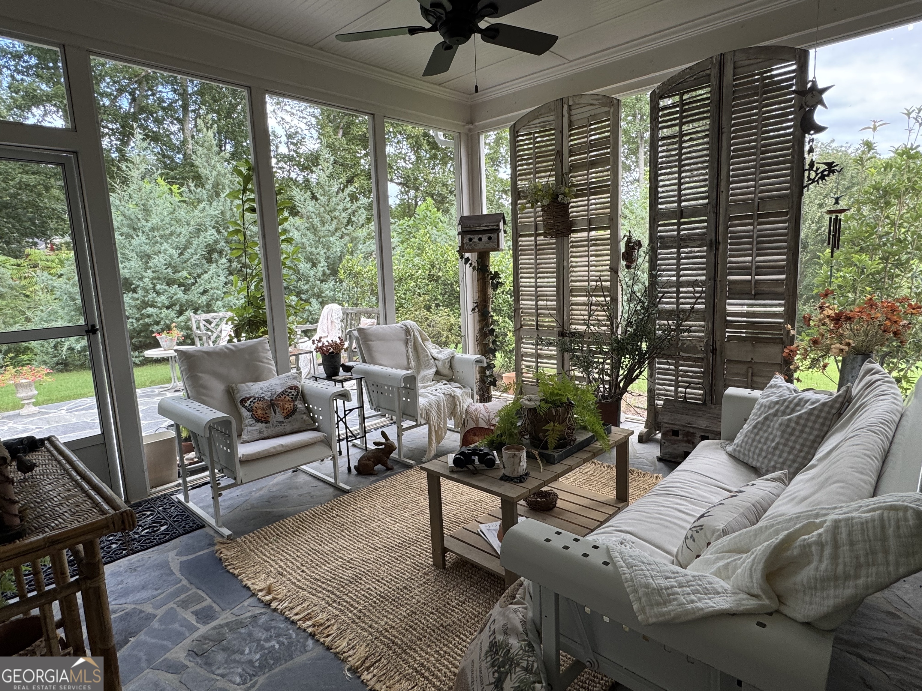 5947 Maple Bluff Way Hoschton, GA 30548 - Photo 4 of 32 a living room with furniture and a floor to ceiling window