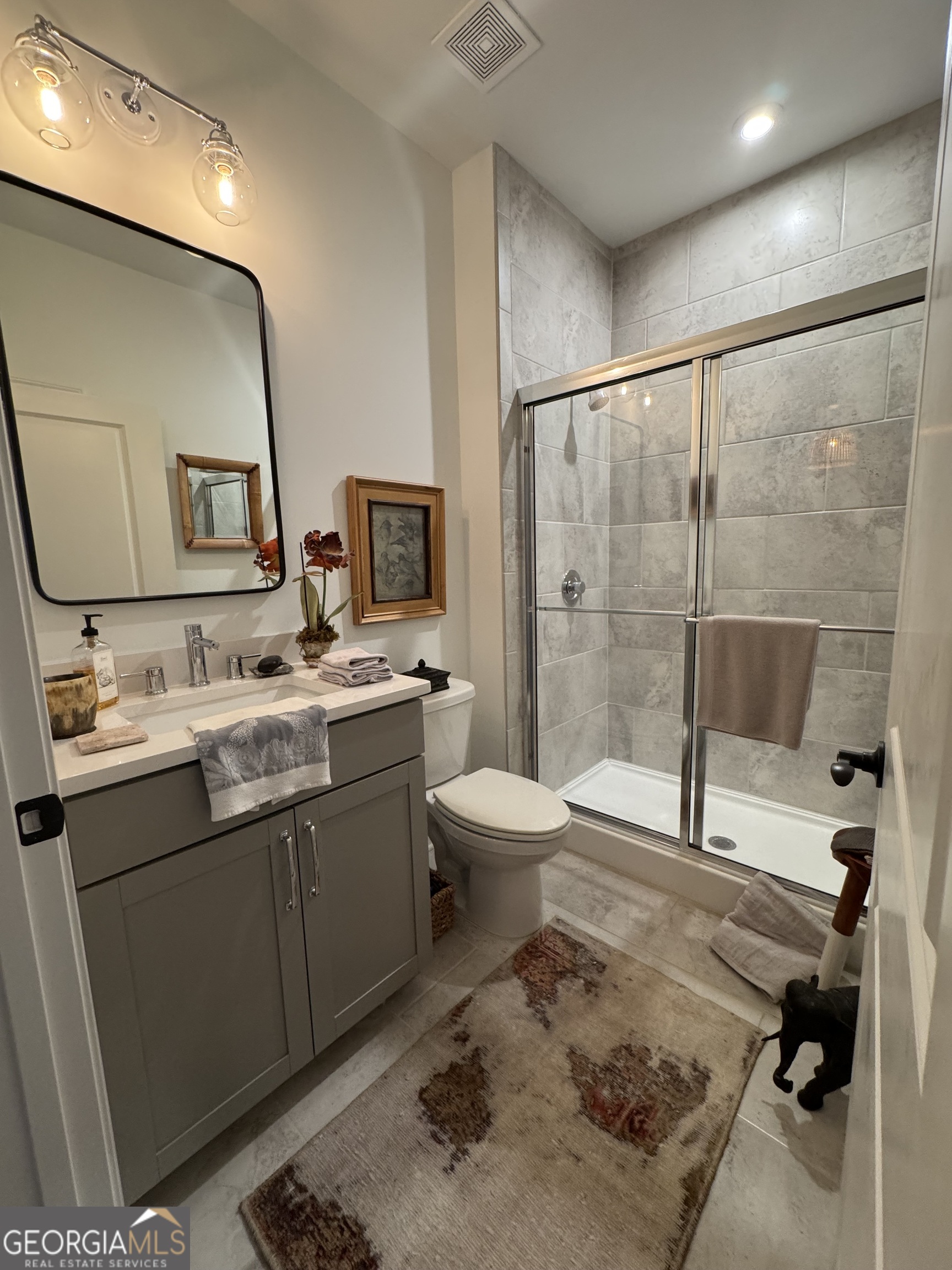 5947 Maple Bluff Way Hoschton, GA 30548 - Photo 7 of 32 a bathroom with a sink toilet and shower