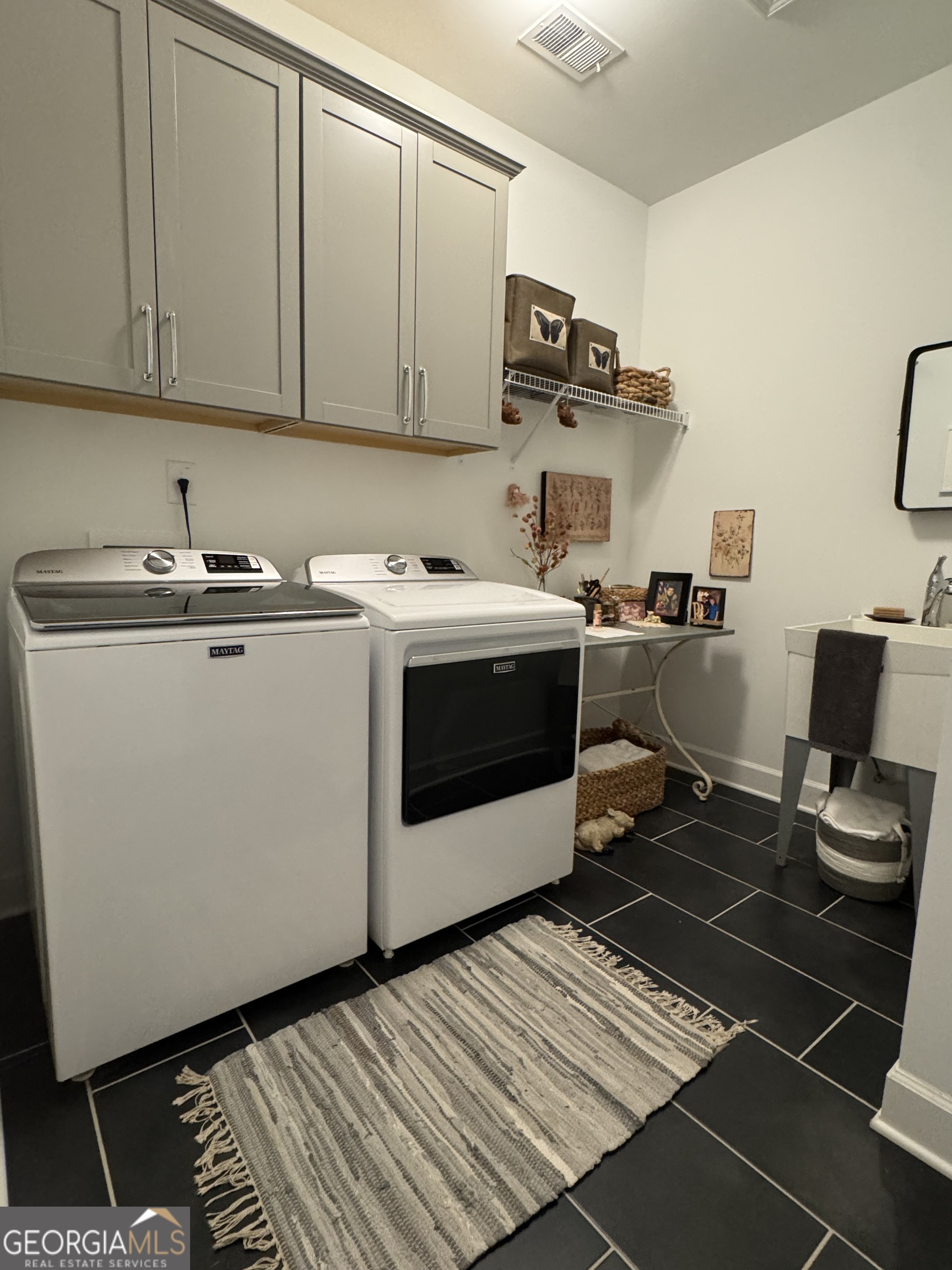 5947 Maple Bluff Way Hoschton, GA 30548 - Photo 9 of 32 a view of a kitchen with sink and washing machine