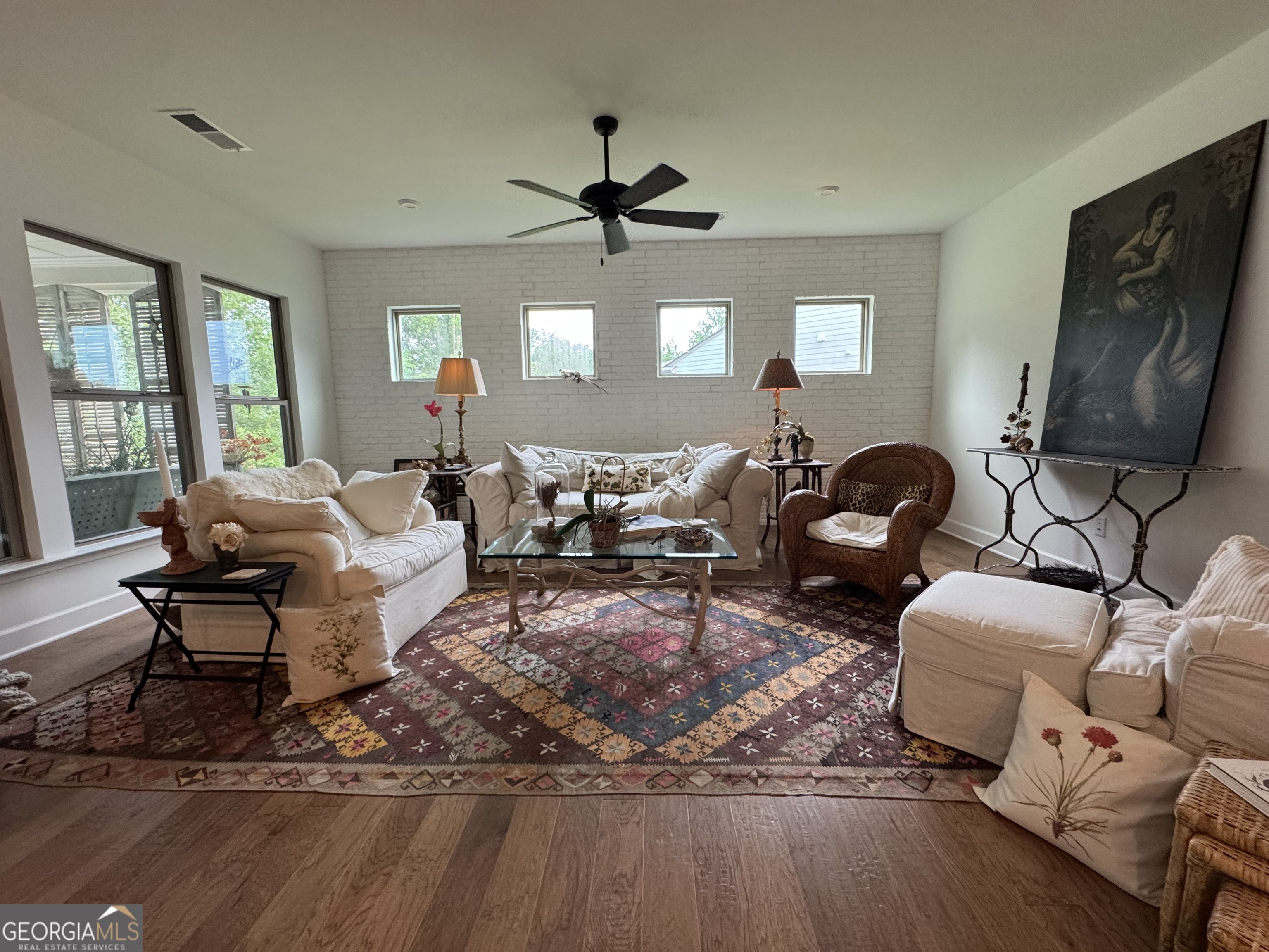 5947 Maple Bluff Way Hoschton, GA 30548 - Photo 10 of 32 a living room with furniture floor to ceiling window and a flat screen tv